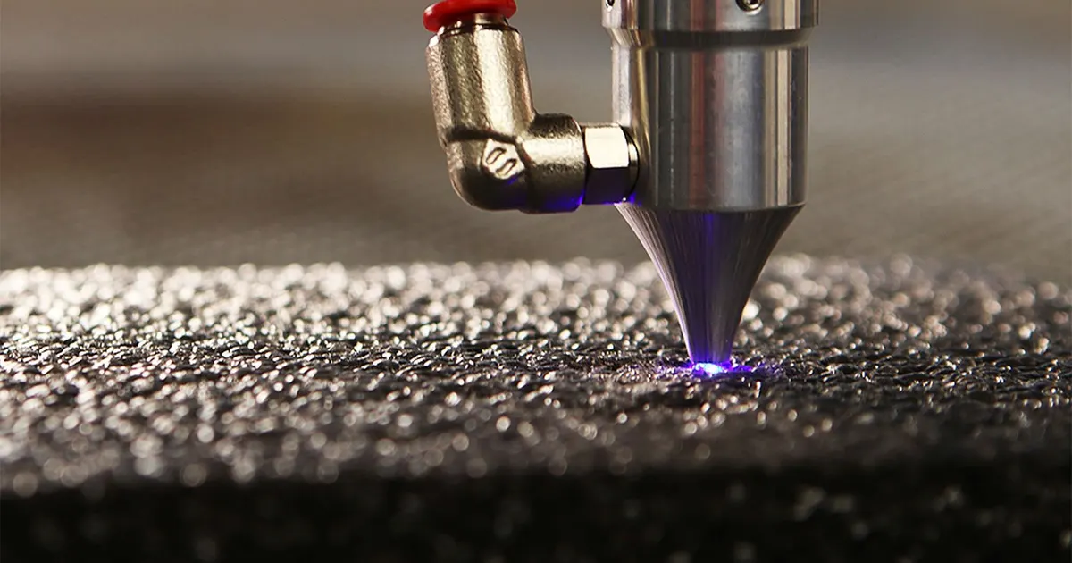 Laser engraver nozzle with an air line working on a metal surface, the process used for laser engraving anodized bike parts